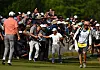 C.T. Pan of Chinese Taipei, center, greets fans on the 15th hole during the third round of the RBC Canadian Open at Oakdale Golf & Country Club on Saturday in Toronto, Canada. [GETTY IMAGES]