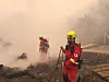 Two firefighters extinguish a blaze that erupted in Sancheong County in South Gyeongsang two days ago in a photo provided by the Korea Forest Service on March 23. [KOREA FOREST SERVICE]