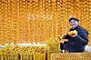 A man prepares persimmons for drying in Hamyang County, South Gyeongsang, on Tuesday. [HAMYANG COUNTY]