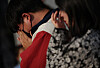 Mourners wipe away tears at one of the makeshift memorials for the victims of the Itaewon crowd crush located at Seoul Plaza, Jung District, central Seoul on Tuesday. [YONHAP]