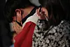 Mourners wipe away tears at one of the makeshift memorials for the victims of the Itaewon crowd crush located at Seoul Plaza, Jung District, central Seoul on Tuesday. [YONHAP]