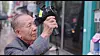 Former Busan International Film Festival director Kim Dong-ho films with his camcorder in a scene from documentary film 'Walking in the Movies,' directed by Kim Lyang. [SCREEN CAPTURE]