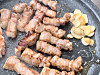 Samgyeopsal abd some garlic on the grill at Jamdubong The Nine in Mapo District, western Seoul [LEE JIAN]