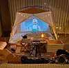 A growing number of people, especially families with children, enjoy camping at home by setting up a tent in the middle of the living room. [NAM JEONG-MIN]