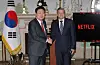 President Yoon Suk Yeol, left, shakes hands with Netflix co-CEO Ted Sarandos in a meeting at Blair House in Washington on Monday. [JOINT PRESS CORPS]