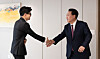 People Power Party interim leader Han Dong-hoon, left, greeted by President Yoon Suk Yeol at the president's office in Yongsan, Seoul, on Monday. The meeting between the two men took place a week after they met at a market in Seocheon County, South Chungcheong, that was destroyed by a fire. [PRESIDENTIAL OFFICE]