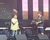 Huh Gak, left, and the intruder that snatched Huh's microphone away from him [SCREEN CAPTURE]