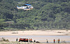 A helicopter hovers over Naeseong Stream in Yecheon County, North Gyeongsang, on Wednesday in search of a marine who was swept away while looking for missing persons that morning. None of the marines in the search and rescue team were wearing life jackets at the time of the accident. The body of a man in his 70s was also found along the stream. Yecheon was hit hard by downpours last weekend, with landslides causing large numbers of deaths and evacuations.  [YONHAP]