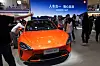 Visitors look at a Xiaomi SU7 car on display during the Auto China 2024 in Beijing on April 28, 2024. [AP/YONHAP]