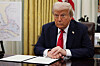 U.S. President Donald Trump prepares to sign an executive order related to the U.S. live entertainment ticketing industry in the Oval Office at the White House in Washington on March 31. [REUTERS/YONHAP]