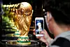 A visitor photographs the World Cup trophy at The Hyundai Seoul in Yeouido, western Seoul. The trophy stopped in Korea to kick off the second leg of its world tour ahead of the 2022 Qatar World Cup in November. [NEWS1]