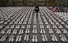 A customs officer examines fake luxury sneakers at the Busan Regional Customs office on Thursday. The customs office announced Thursday it caught three people who smuggled some 2,000 fake Nike, Gucci and Balenciaga sneakers worth 1.7 billion won ($1.5 million) into Korea. [SONG BONG-GEUN]