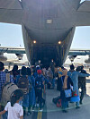 Afghans bound for Korea board a Korean Air Force transport plane at the Kabul airport Tuesday, local time. The Korean government flew three military aircraft to Pakistan earlier this week to airlift 390 Afghan evacuees, including 100 children. [FOREIGN MINISTRY]
