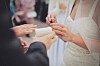 A bride and groom exchange wedding rings [PIXNIO]
