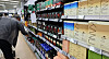 A shopper picks out an instant coffee mix from a shelf containing assorted instant coffee products at a market in Seoul on Tuesday. [NEWS1]