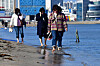 Visitors dip their feet into the waters of Songdo Beach in Pohang, North Gyeongsang, on Tuesday. Pohang's midday high reached 17.9 degrees Celsius (64.2 degrees Fahrenheit) on the same day.[NEWS1]