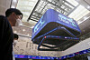 People walk under screens at the Korea Exchange in Yeouido, western Seoul on Oct. 7. [ASSOCIATED PRESS]