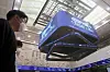 People walk under screens at the Korea Exchange in Yeouido, western Seoul on Oct. 7. [ASSOCIATED PRESS]