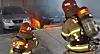 Firefighters work to extinguish a blaze that broke out from an EV car in a parking lot in South Chungcheong. [NEWS1]