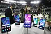 Reporters try out the Galaxy S21 Fan Edition (FE) 5G model introduced by Samsung Electronics on Tuesday, a day before the CES 2022 tech festival opens in the Las Vegas Convention Center. The new phone will be cheaper but have features similar to the company's flagship Galaxy S21. [YONHAP]