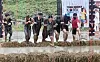 Visitors to the Boryeong Mud Festival in South Chungcheong try a 'Tough Mudder' obstacle course on Saturday. [NEWS1]