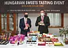 Mozes Csoma, ambassador of Hungary to Korea, right, poses for a photo with a box of chocolates during a Hungarian Sweets Tasting Event held at the Hungarian Embassy in Yongsan District, central Seoul, on Thursday. Products from a total of six Hungarian confectionery companies including chocoMe, Detki and Szerencsi Bonbon were introduced for tasting during the event as part of efforts to help Hungarian companies that wish to become export partners with the Korean market. [PARK SANG-MOON]