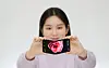 A model showcases Samsung Display’s latest In&Out Flip which wasunveiled at CES 2024 in Las Vegas. [SAMSUNG DISPLAY]
