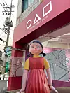 Younghee, the giant robot doll from Netflix's 'Squid Game,' stands in front of an experience zone set up in Dobong District, northern Seoul, on Tuesday. Visitors can try activities featured on the show, such as making dalgona, a retro candy made by melting sugar, and play marbles. The experience zone is open through January next year. [YONHAP]