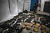 An Israeli soldier walks near armaments during an official media tour organized by the Israeli military on Oct. 26, where it displayed a variety of weapons recovered from areas hit by the Palestinian Hamas militants during their Oct. 7 attack on communities across southern Israel. Israel's military on Oct. 26 said a portion of the weapons used by Hamas during the militant group's Oct. 7 attacks were made in Iran and North Korea. [AFP/YONHAP]