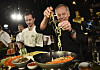 Chef Wolfgang Puck, right, and his son Byron make a pasta dish at the Governors Ball Press Preview for the 92nd Academy Awards in Los Angeles on Jan. 31, 2020. A new four-part documentary series, “The Event,” shows the intense planning and details that go into high-profile catering. [AP/YONHAP]