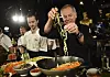 Chef Wolfgang Puck, right, and his son Byron make a pasta dish at the Governors Ball Press Preview for the 92nd Academy Awards in Los Angeles on Jan. 31, 2020. A new four-part documentary series, “The Event,” shows the intense planning and details that go into high-profile catering. [AP/YONHAP]