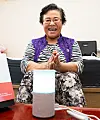 A woman in her 60s listens to SK Telecom AI speaker Nugu. [SK TELECOM]