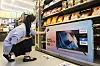 A customer looks at a Smart Full HD TV from Emart's 'I'm e' brand at an Emart 24 convenience store in Seongdong District, eastern Seoul, on Wednesday. The convenience store chain said that the smart TV, introduced in June under its brand, sold around 650 units so far. [YONHAP]