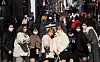Japanese tourists pose for a photo on the streets of Myeong-dong, central Seoul, on Wednesday. Myeong-dong is one of Korea's most popular tourist attractions for shopping and tourists are returning in droves now that most Covid restrictions have been lifted. [YONHAP]