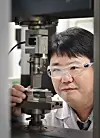 A researcher from LG Chem inspects the first eco-friendly recycled acrylonitrile butadiene styrene in white. [LG CHEM]