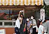 On Aug. 4, 2022, visitors pose in front of the actual ″Woo Young-woo Gimbap″ restaurant from the show, located in Suwon, Gyeonggi. [YONHAP]