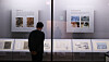 A visitor looks at cultural heritages that have recently completed receiving preservation treatments at the 'Bohwasubo' exhibit, the first exhibit in seven years at the Kansong Art Museum, also known as Bohwagak, in Seongbuk District, central Seoul, on Friday during the exhibit's pre-opening. [YONHAP]