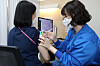 A medical staffer receives a Covid-19 booster shot on Tuesday at the National Medical Center in central Seoul. [YONHAP]