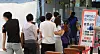 People wait in line at a Covid-19 testing site in Daejeon on Monday. [NEWS1]