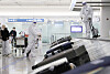 Staff disinfect luggage at Terminal 1 of Incheon International Airport. [YONHAP]