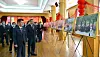North Korean officials and Chinese Ambassador to North Korea Li Jinjun view a photo exhibition at the Chinese Embassy in Pyongyang to mark the second anniversary of Chinese President Xi Jinping's first state visit to the country in 2019 for a summit with leader Kim Jong-un in a photograph carried by the North's official Rodong Sinmun. [RODONG SINMUN]
