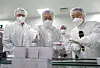 President Moon Jae-in, center, and SK Group Chairman Chey Tae-won, left, look at vaccine development facilities during a visit to SK Bioscience's factory in Andong, North Gyeongsang. [JOINT PRESS CORPS]