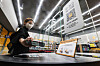 An Emart24 employee checks into an unmanned convenience store in Coex, southern Seoul, using a QR code on Thursday. Customers can enter the store after receiving a QR code when they register a credit or debit card. They can pick up products and leave the store without scanning their purchases, with payments processed automatically. [YONHAP]