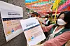 An employee poses with a poster about promotional event at Jogye Temple in Jongno District, central Seoul on June 1. Starting this month, vaccinated people or those who received their first jab will be offered to 20,000 won discounts on all temple stay programs in 135 temples across the country. [NEWS1]