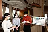 An employee of The Courtyard by Marriott Seoul Times Square talks to customers about a promotional event at its buffet restaurant in Yeongdeungpo District, western Seoul. The hotel offers breakfast buffet at 100 won ($0.09) for customers vaccinated, as well as their companions, if they are staying at the hotel. [JANG JIN-YOUNG]