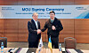 Posco International CEO Jeong Tak, left, and Governor Vitalii Kim of the Mykolaiv region pose for a photo during a signing ceremony on Tuesday in Kyiv for the company's modular construction business in Ukraine. [POSCO INTERNATIONAL]