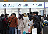 Passengers wait in line to check in for a flight heading to Narita International Airport at Incheon International Airport Terminal 1 on Sunday. [YONHAP]