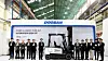 Doosan Bobcat Korea President Park Hyung-won, seventh from the left, takes a photo during a roll-out ceremony of Korea's first commercialized hydrogen fuel cell forklift, held at its production plant in Incheon on Monday, along with other attendees including Deputy Minister Lee Chang-heum of the Ministry of Environment, sixth from left. [DOOSAN BOBCAT]