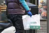 A delivery man is leaving a fried chicken store with pakaged food [YONHAP]