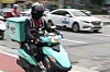A delivery man rides a motorcycle to deliver food to respective customers. [NEWS1]